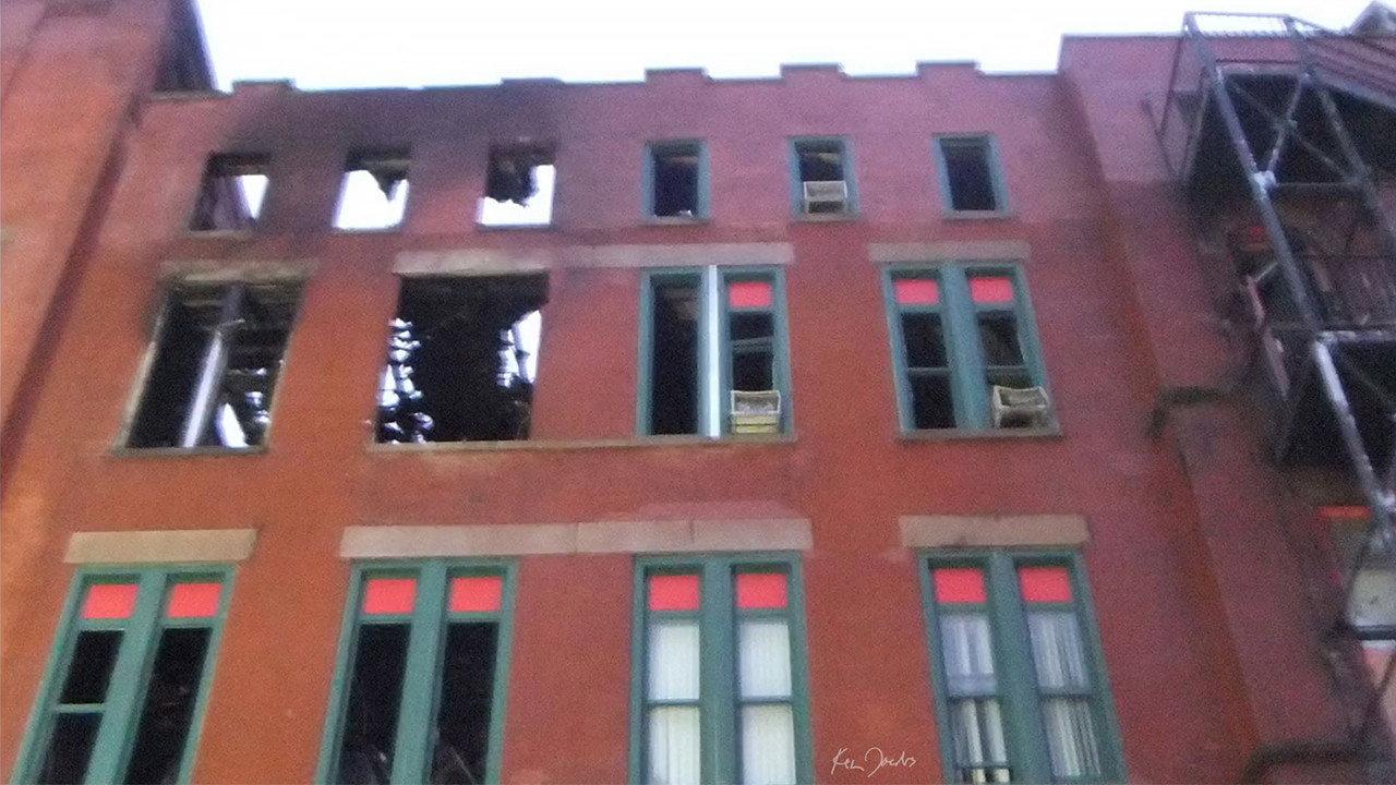 Brick Building with Red and Green Windows 2020 movie scene