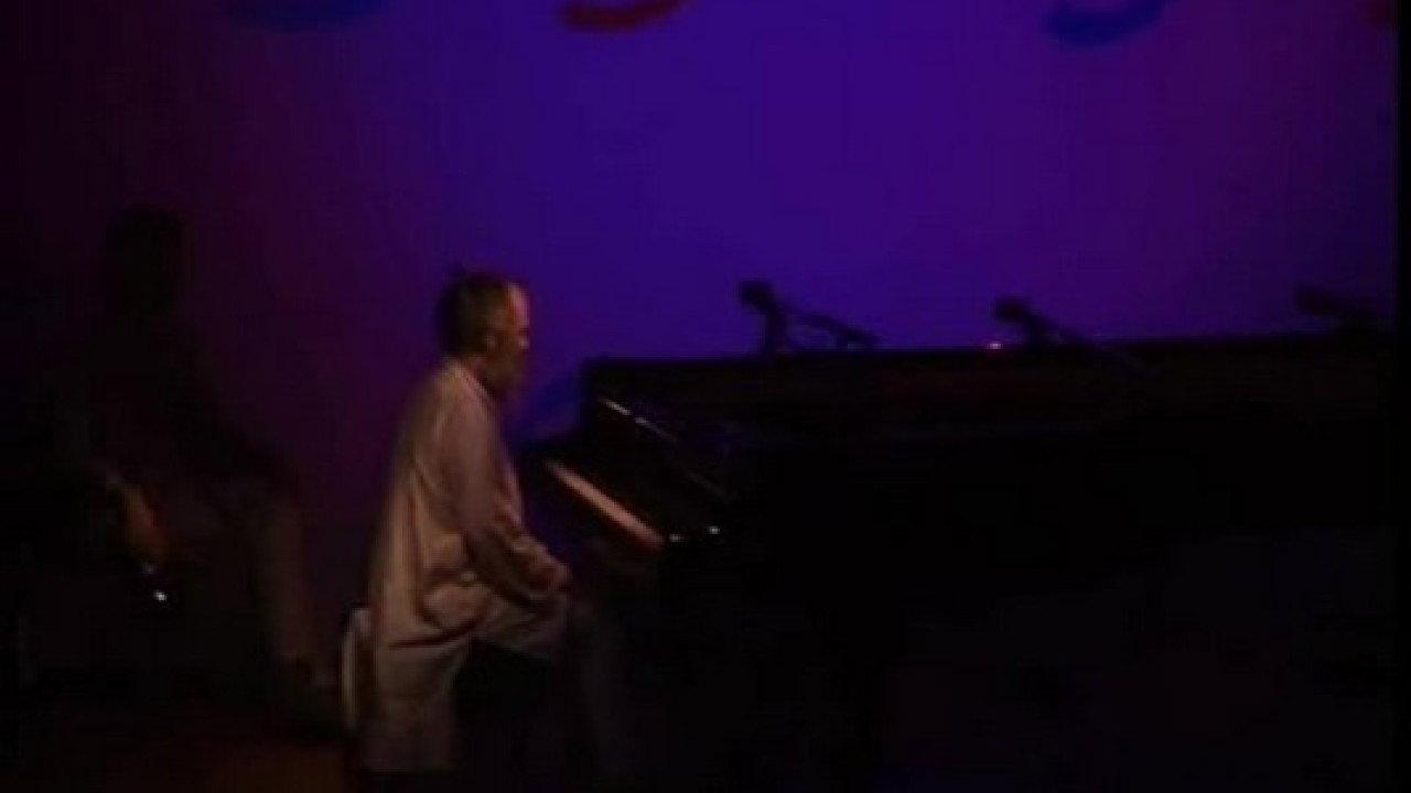 The Well-Tuned Piano in the Magenta Lights 2000 movie scene