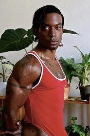 Jonzu Jones as Roman in Remember I Am Dead 2024