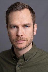 Ali Cook as Simon in How to Fake a War 2020
