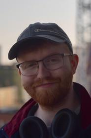 J.J. Vaughan as Kismet commercials voice / Plane passenger in The Kismet Test 2026