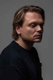 Stanislav Tiunov as Policeman with a Flashlight in 10 Little Bloggers 2025
