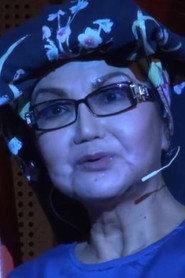 Mutiara Sani as Emak Sahat in A Moon Hangs Above the Graveyard 2015