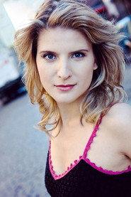 Katie Fabel as Woman on TV in So Fly Christmas 2023