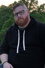 Adam Myles as Paranormal Investigator in Ghost Island 2025