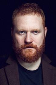 Simon Holland Roberts as La Tremouille/Page/Gentleman in National Theatre Live: Saint Joan 2017