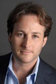 Adam Waxman as Man in Suit in The Christmas Spirit 2022