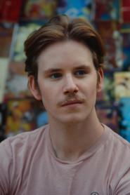 Harrison Kraft as The Young Man in Capsules 2023