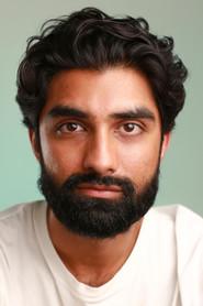 Ankitt Bhatt as John in LOCKED IN 2026