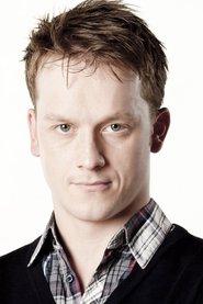 Jolyon Coy as The Travel Agent in Thanks for the Memories 2019