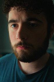 Isaac Bass as Coach in The Marked Room 2028