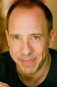 Patrick Richwood as John Barnard in Dark Side of Genius 1994