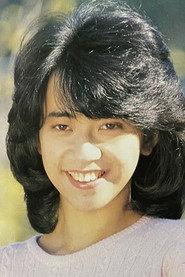 Hitomi Hoshi as Yuka Kobashi, Morio's fiancée in Inbi 1987
