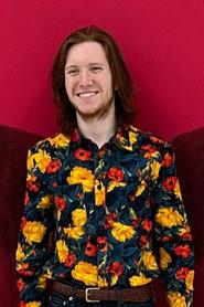 Evan Sanders as Exhibition Visitor in Passing Portrait 2026