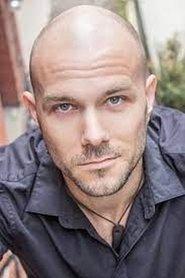 T.J. Kennedy as Mercenary #1 in Raider Origins 2013