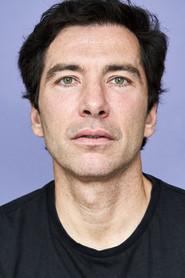 Albert Tallski as The Professional in Tales of Babylon 2023