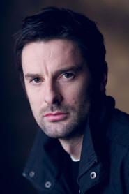 Tom Ward as Roger Penrose in Hawking 2004
