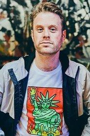 Dylan Saunders as Father Otto in Indulge Me 2024