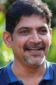 Krishna Hebbale as Ashtamangala Purohitaru in Karavali