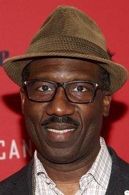 Russell G. Jones as Louis in Too Many Christmases 2024