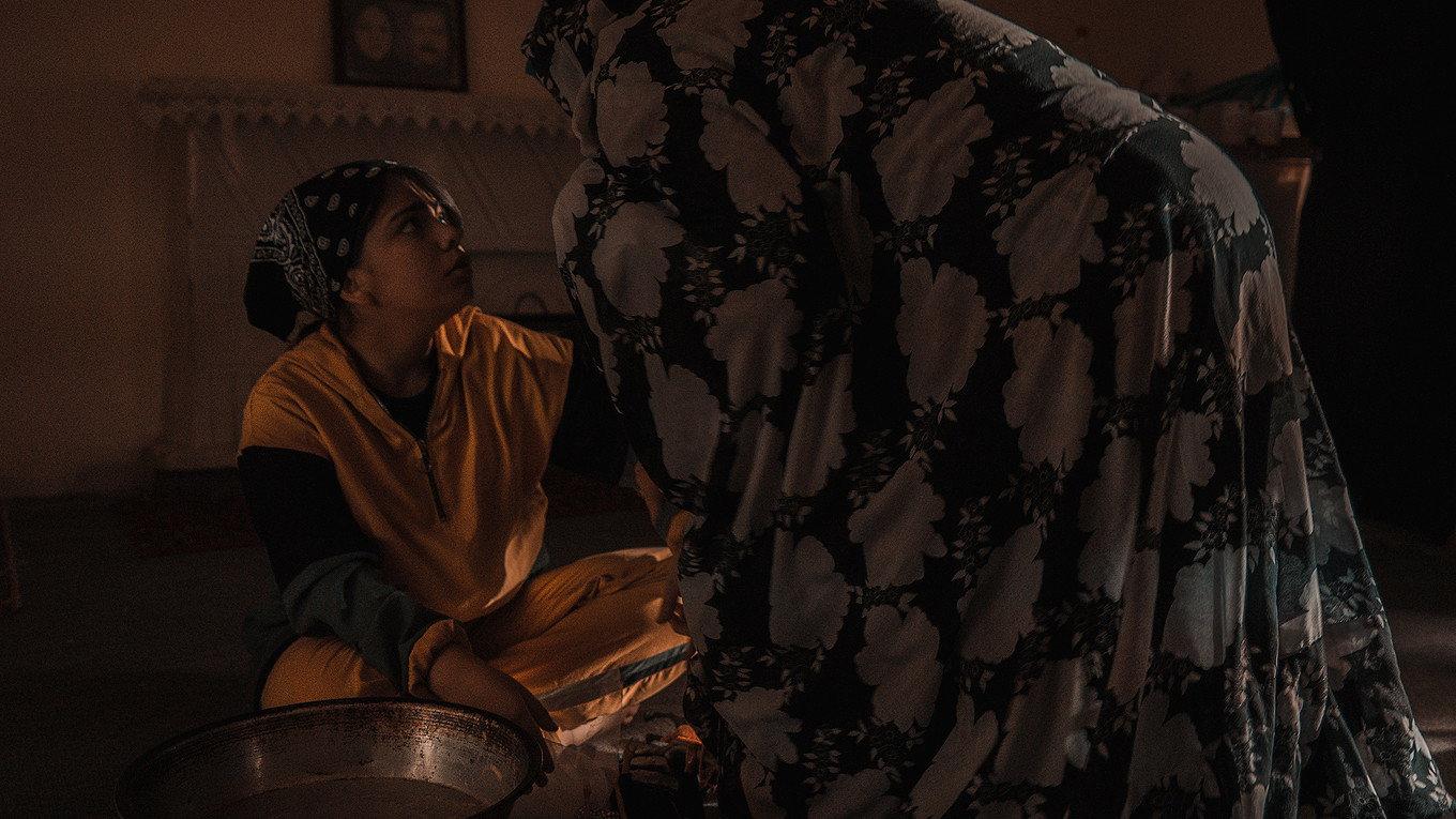 The bride has a doll in her hands 2022 movie scene