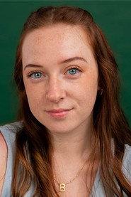 Bee Nickerson as Barbara (Bankteller) in GREED 2026