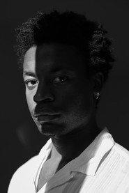 Philippe Kande as Judy in WHO 2026