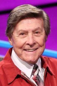 Johnny Gilbert as Jeopardy announcer (voice) in Ellen's Energy Adventure 1996