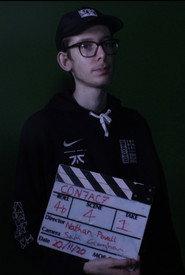 Sam Croghan as The Being / Man in black in C0N7AC7