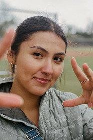 Violet Moralez as Woman 1 in PATRIA 2026